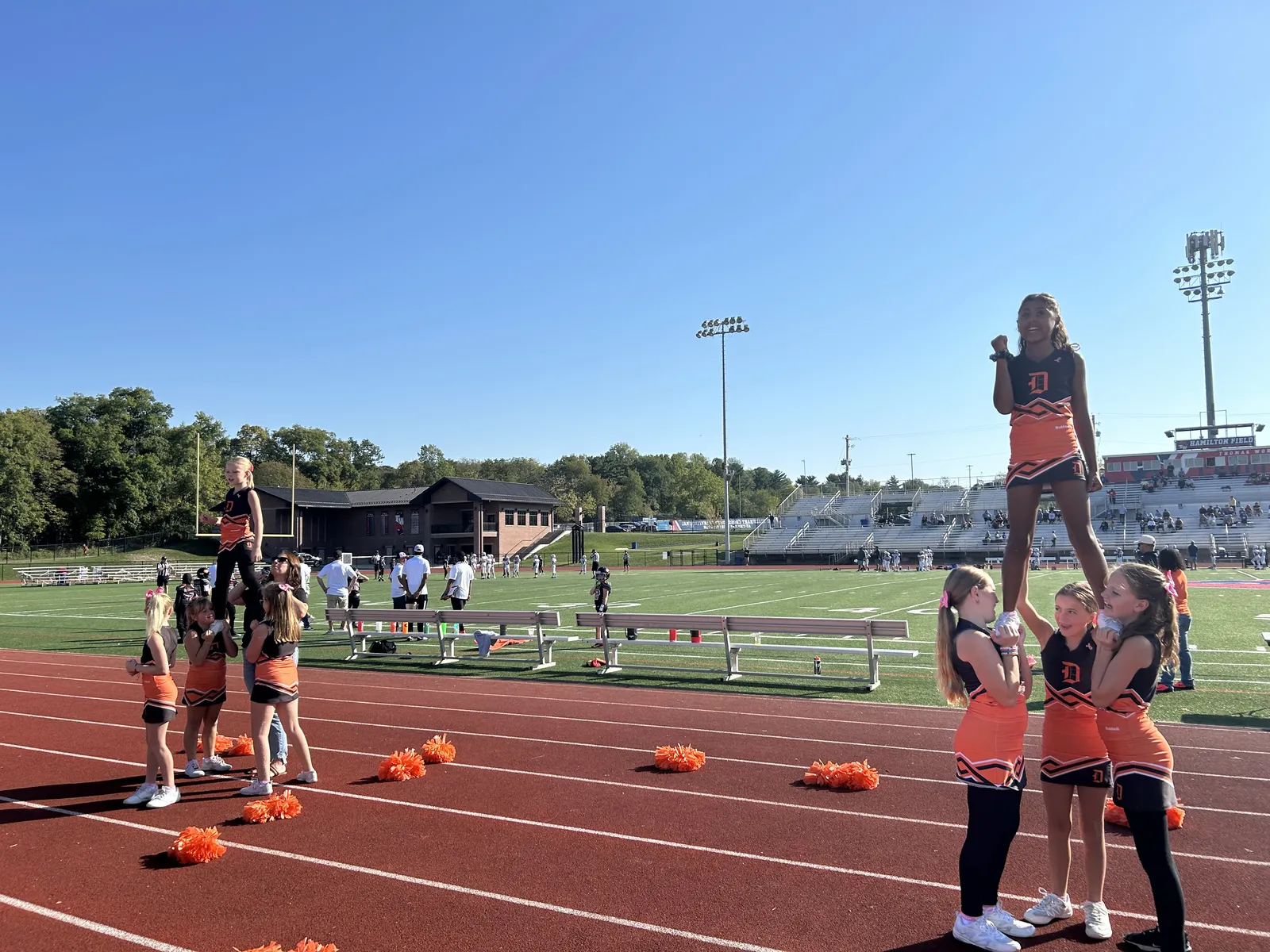 Jr Pacers cheer squad performing a stunt together