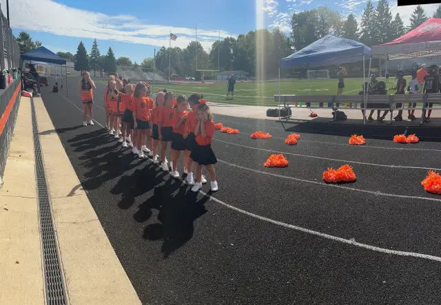 Jr Pacers cheer squad lined up with poms