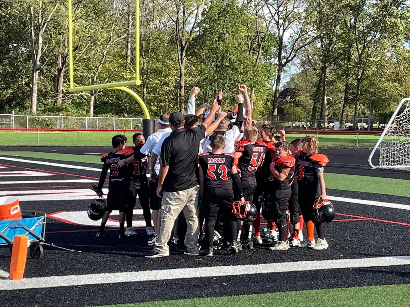 The Jr Pacers celebrating together on the field